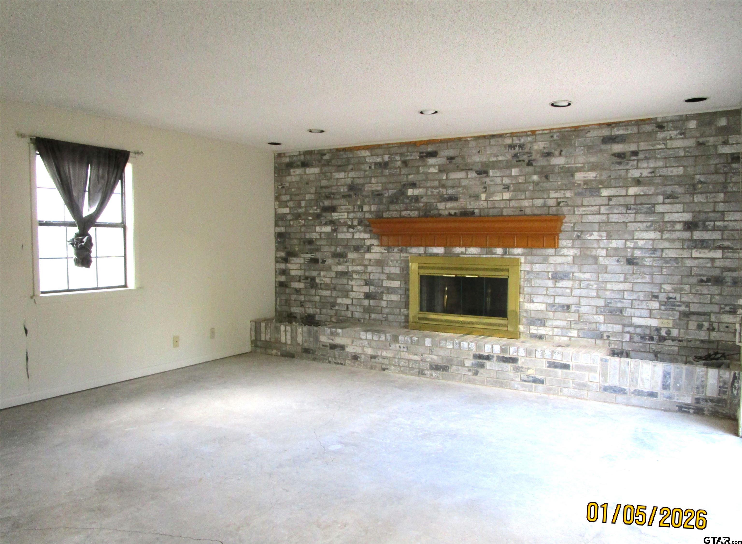 1317 South Butler Avenue Tyler, TX 75701 - Photo 4 of 13 a view of empty room with a fireplace