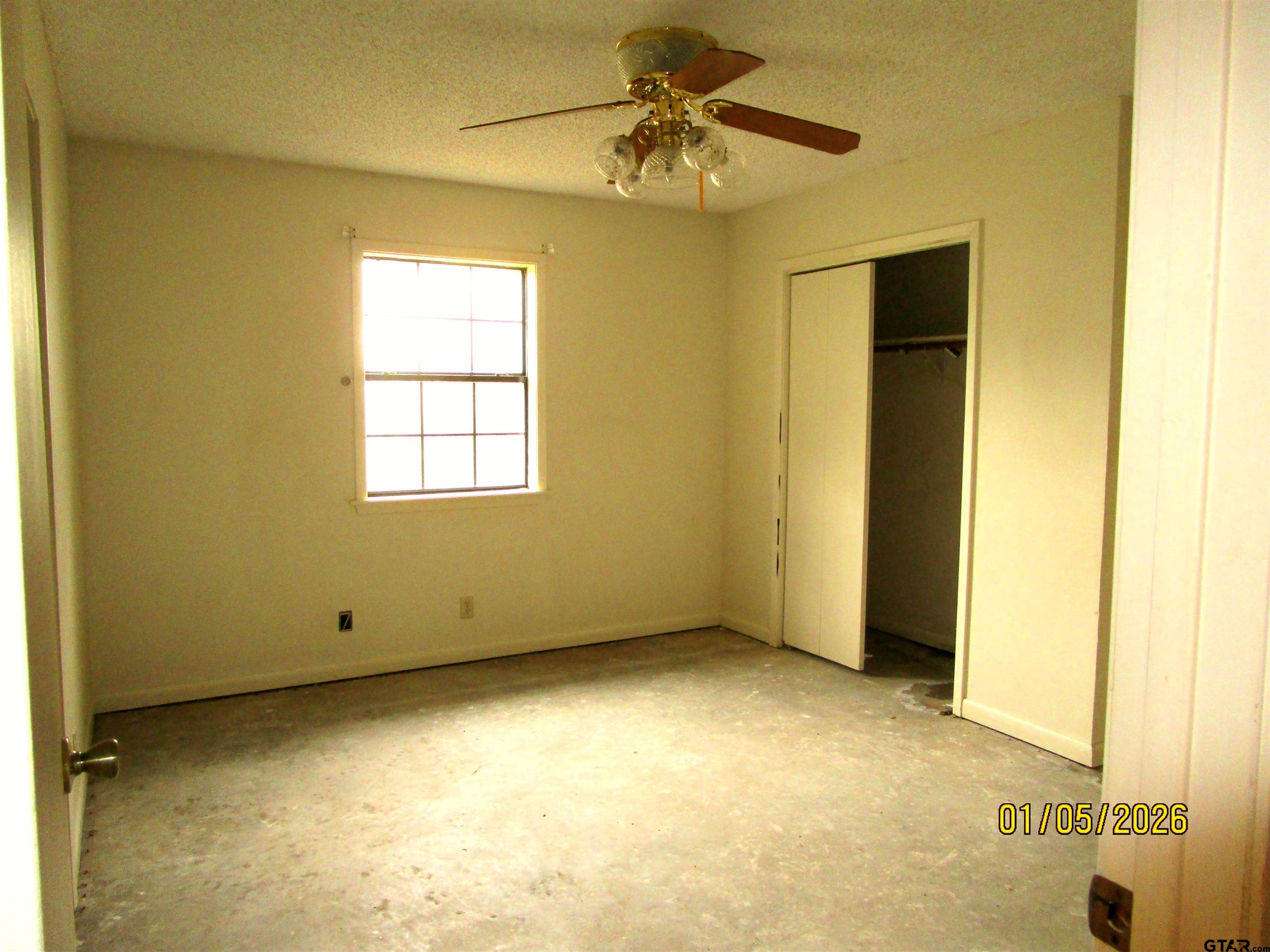 1317 South Butler Avenue Tyler, TX 75701 - Photo 8 of 13 a view of room with window and a ceiling fan