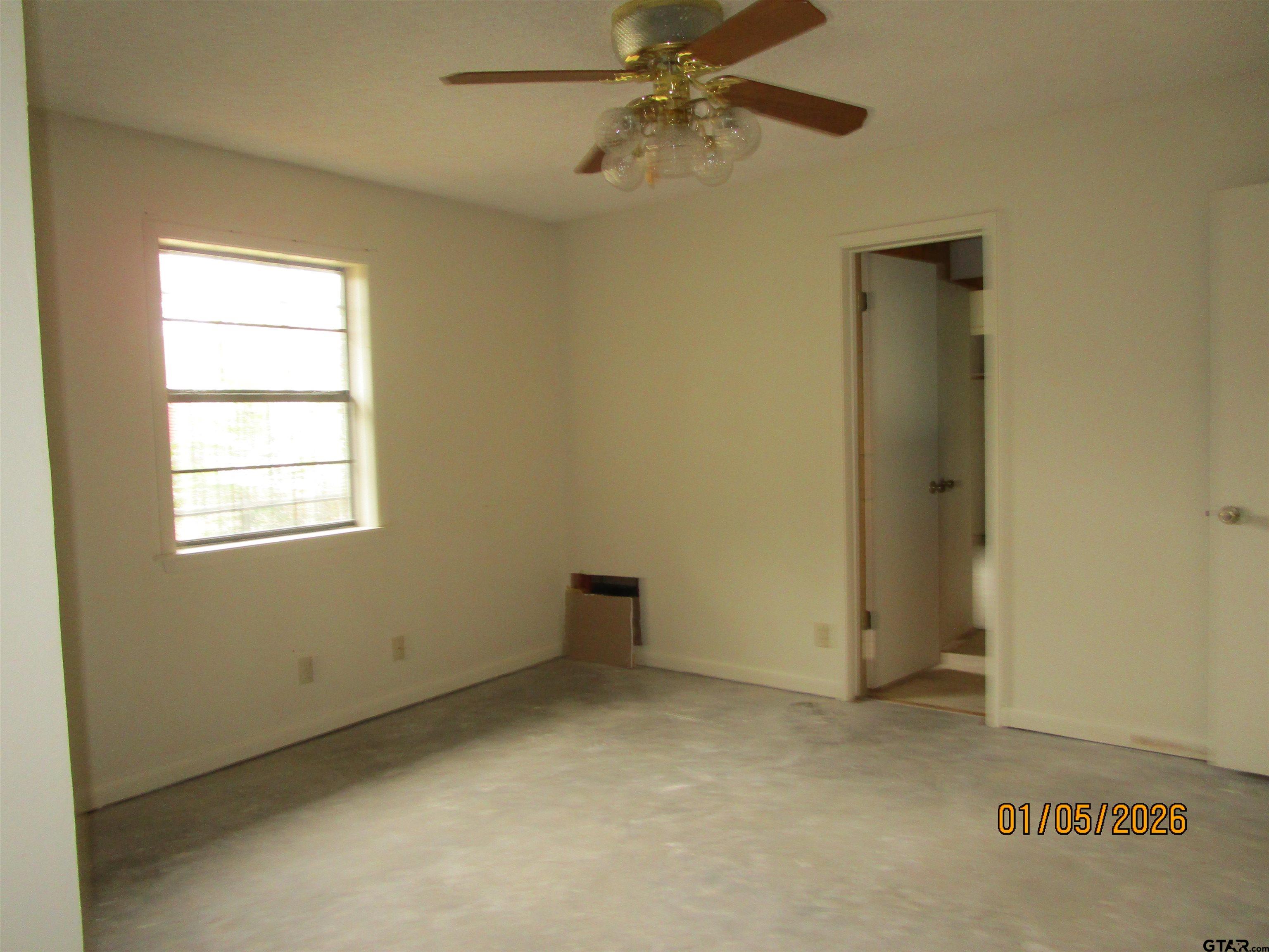 1317 South Butler Avenue Tyler, TX 75701 - Photo 10 of 13 an empty room with windows and fan