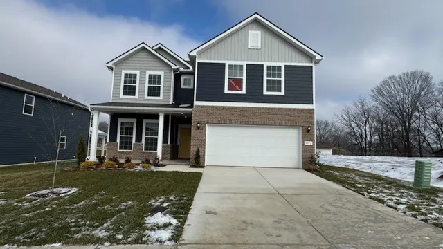 a living room with furniture a flat screen tv and a large window