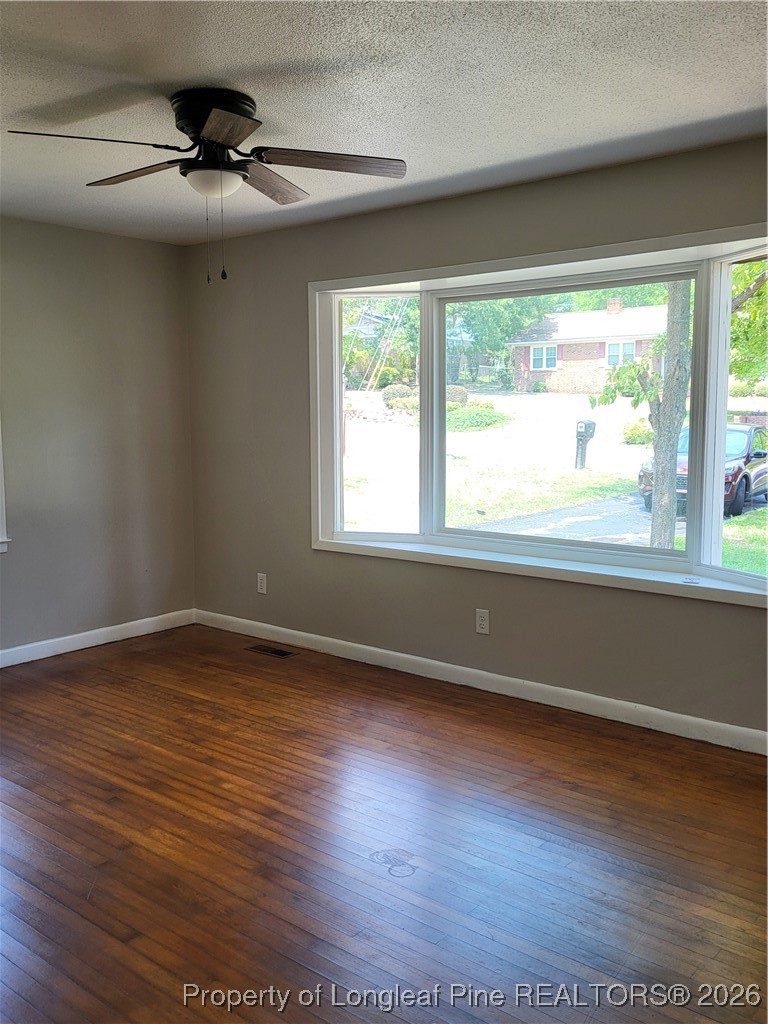 182 Summerhill Road Fayetteville, NC 28303 - Photo 10 of 24 a view of an empty room with wooden floor and a window