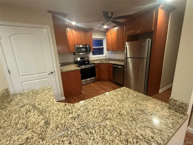 a view of a room with wooden floor and a sink