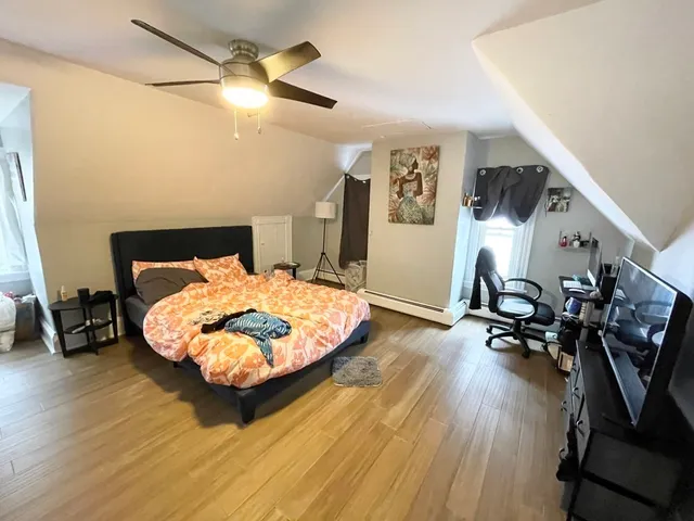 a bedroom with wooden floor