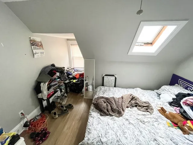 a bedroom with bed and a window