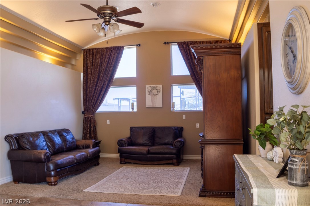 2775 Taylor Street Logandale, NV 89021 - Photo 16 of 41 This living room features vaulted ceilings and ample natural light, creating a bright and airy atmosphere.