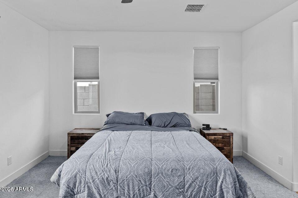 40990 West Agave Road Maricopa, AZ 85138 - Photo 15 of 18 a bedroom with a bed and a window