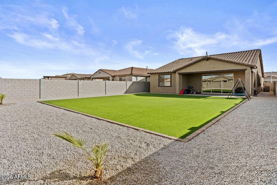 40990 West Agave Road Maricopa, AZ 85138 - Photo 17 of 18 a view of a house with a yard and sitting area