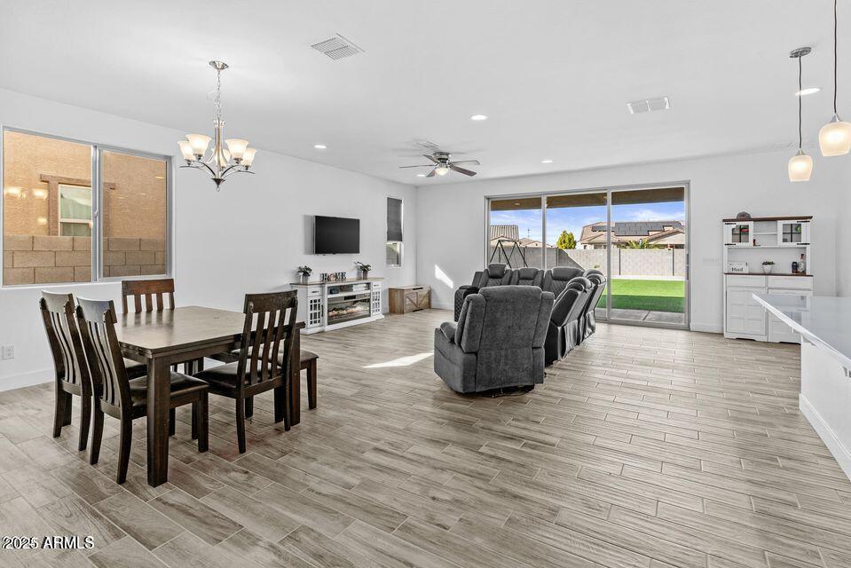 40990 West Agave Road Maricopa, AZ 85138 - Photo 6 of 18 a view of a dining room with furniture window and wooden floor