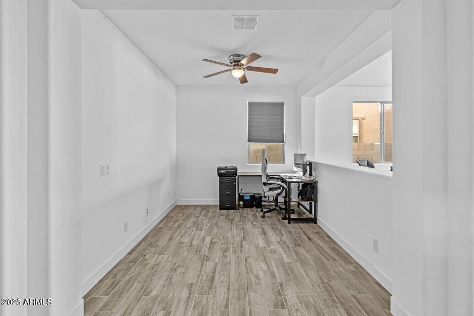 40990 West Agave Road Maricopa, AZ 85138 - Photo 10 of 18 a view of a workspace with furniture and a window