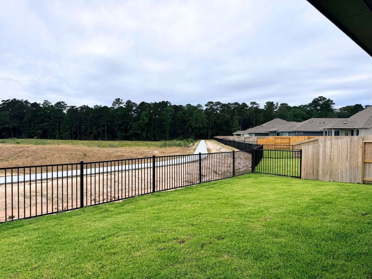16246 Parish Pointe Court Conroe, TX 77302 - Photo 32 of 32 a view of a yard with wooden fence