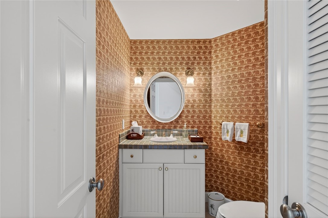 2525 Ocean Drive, Unit 3 Vero Beach, FL 32963 - Photo 11 of 36 a bathroom with a toilet sink vanity tub and mirror
