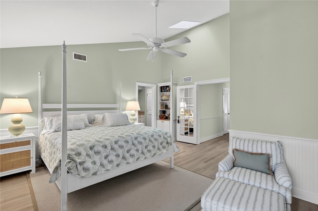 2525 Ocean Drive, Unit 3 Vero Beach, FL 32963 - Photo 12 of 36 a bedroom with a large bed and a chandelier