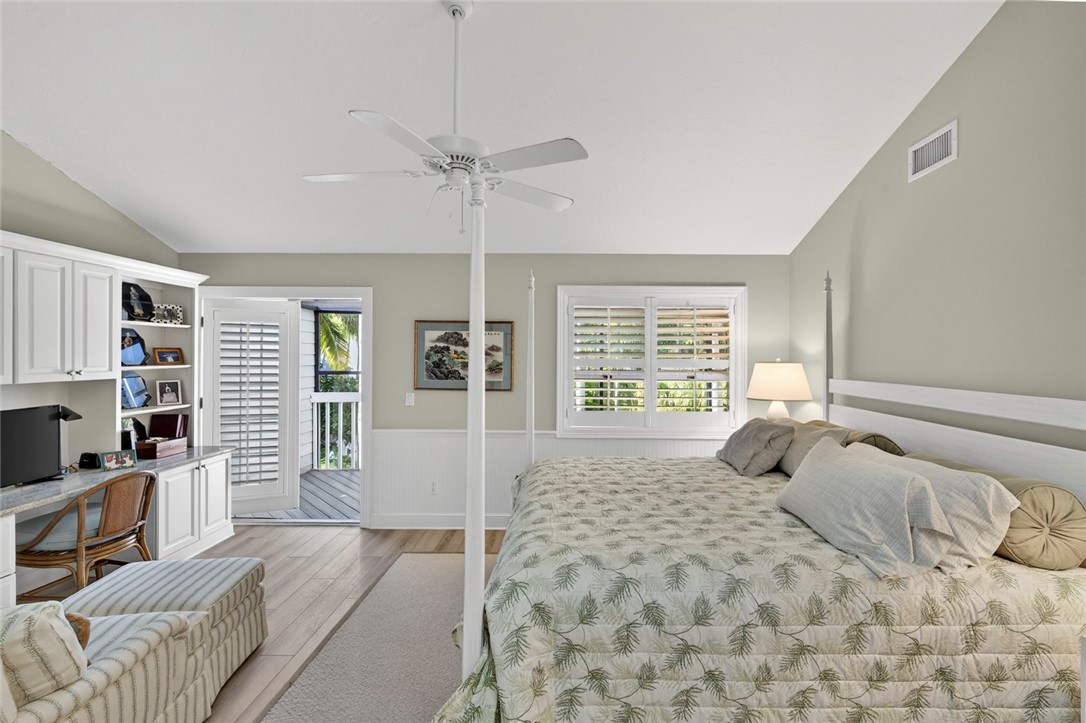 2525 Ocean Drive, Unit 3 Vero Beach, FL 32963 - Photo 13 of 36 a bedroom with a large bed a flat screen tv and a large window