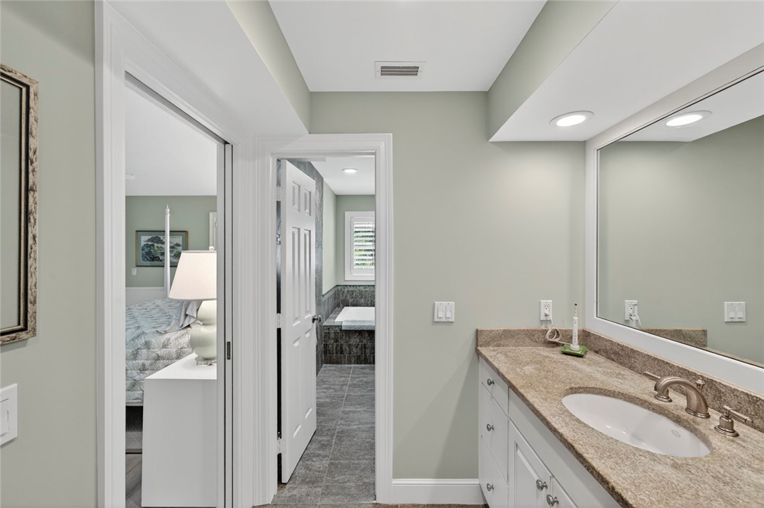 2525 Ocean Drive, Unit 3 Vero Beach, FL 32963 - Photo 16 of 36 a en suite bathroom with a granite countertop sink mirror and shower