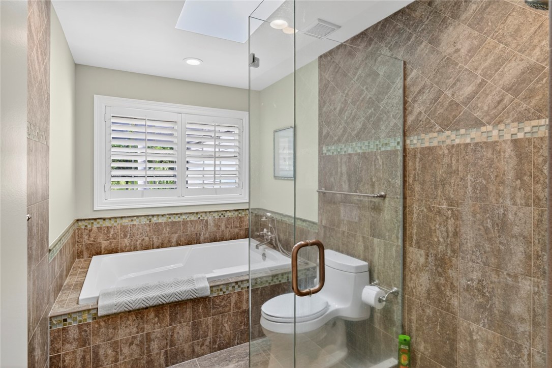 2525 Ocean Drive, Unit 3 Vero Beach, FL 32963 - Photo 17 of 36 a bathroom with a sink a toilet and shower