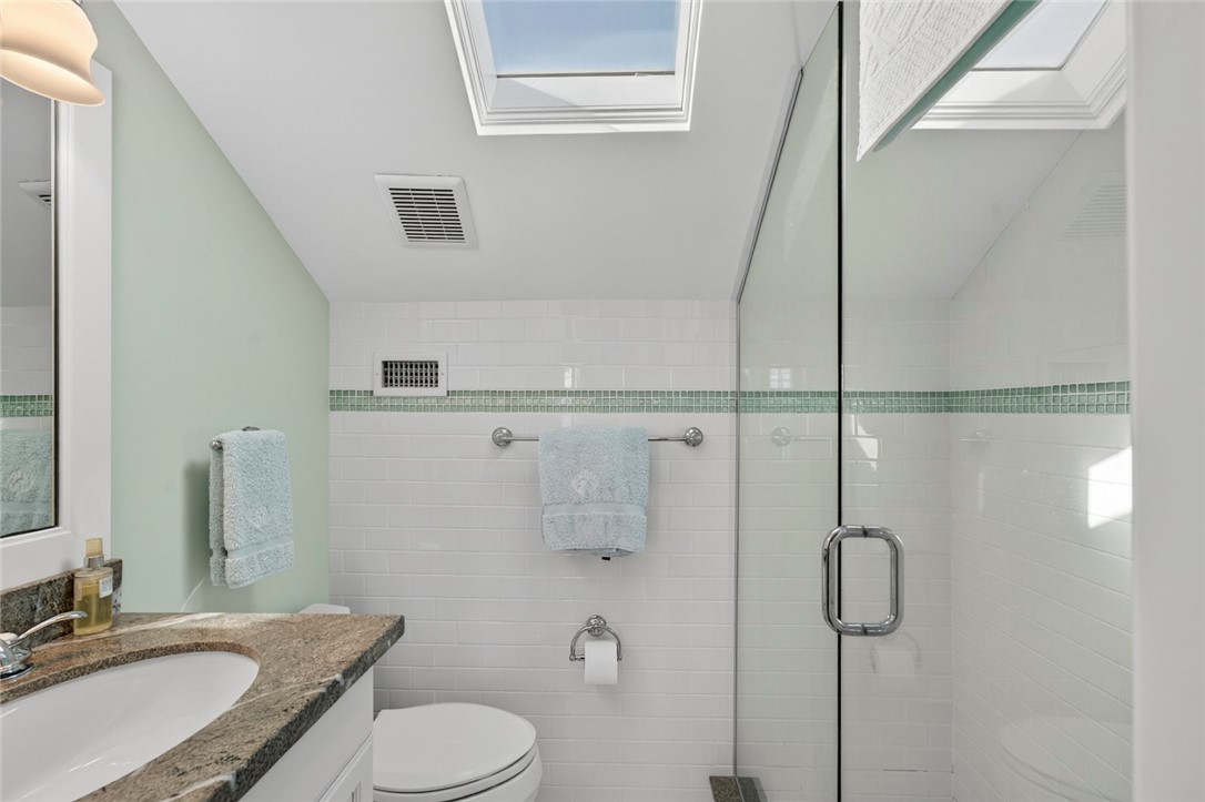 2525 Ocean Drive, Unit 3 Vero Beach, FL 32963 - Photo 27 of 36 a bathroom with a granite countertop sink toilet and shower