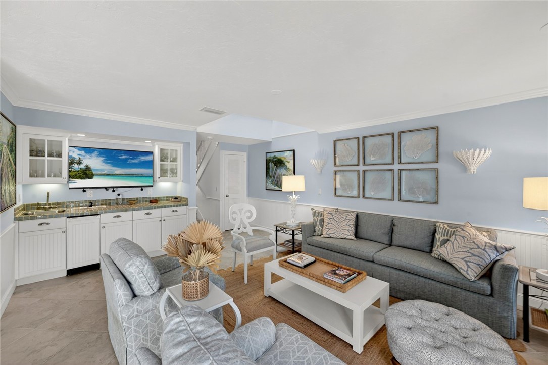 2525 Ocean Drive, Unit 3 Vero Beach, FL 32963 - Photo 5 of 36 a living room with furniture a flat screen tv and kitchen view