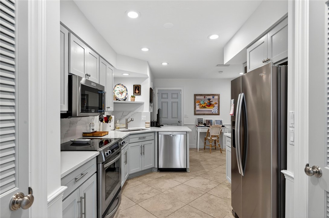 2525 Ocean Drive, Unit 3 Vero Beach, FL 32963 - Photo 10 of 36 a kitchen with a sink stainless steel appliances and cabinets