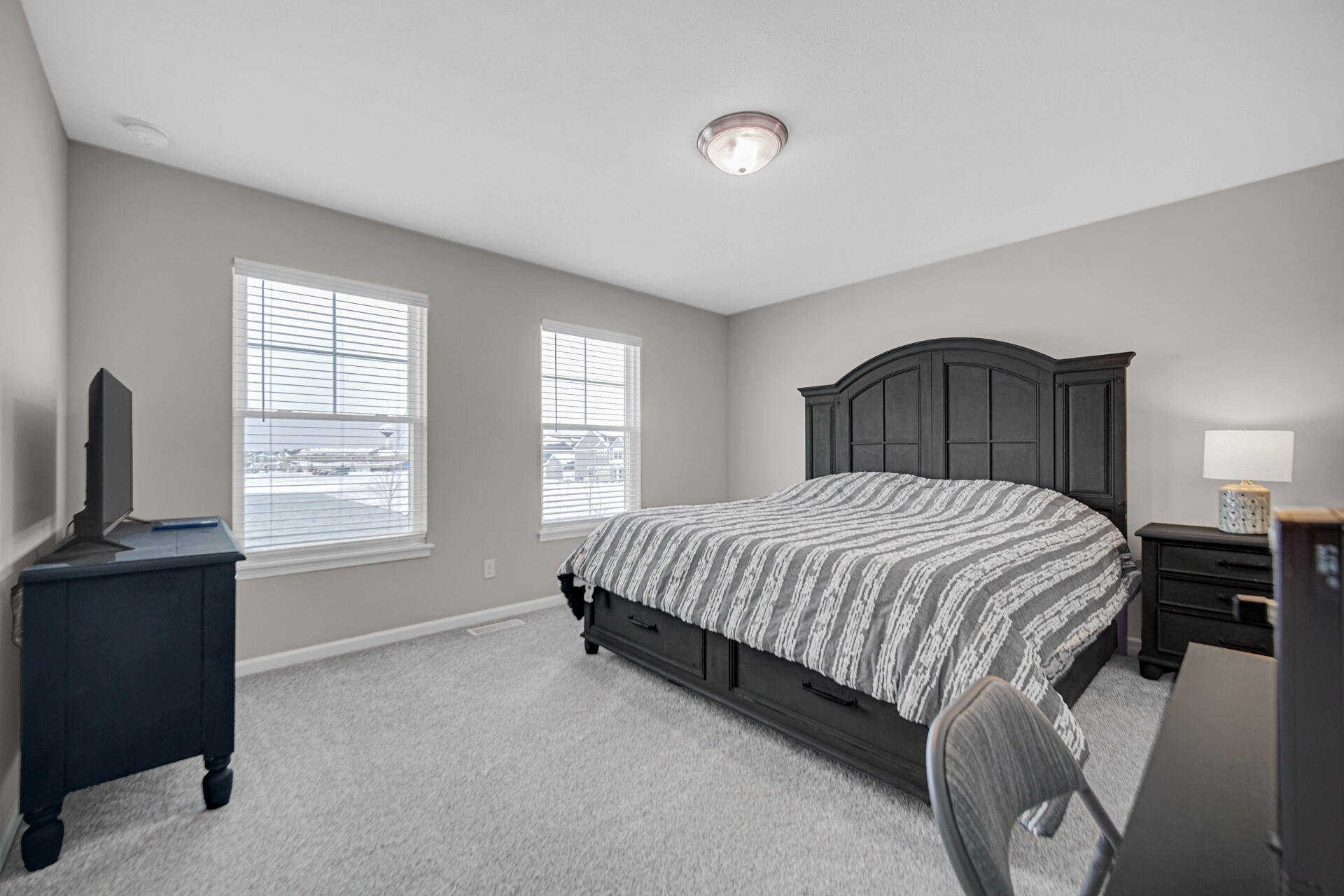 1023 East 117th Lane Crown Point, IN 46307 - Photo 12 of 22 a bed sitting in a bedroom next to a window