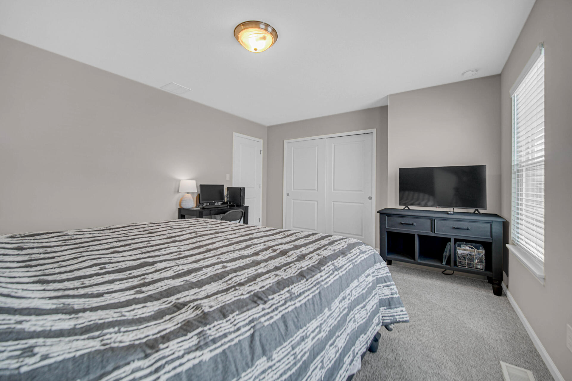 1023 East 117th Lane Crown Point, IN 46307 - Photo 13 of 22 a bedroom with a bed and a flat screen tv