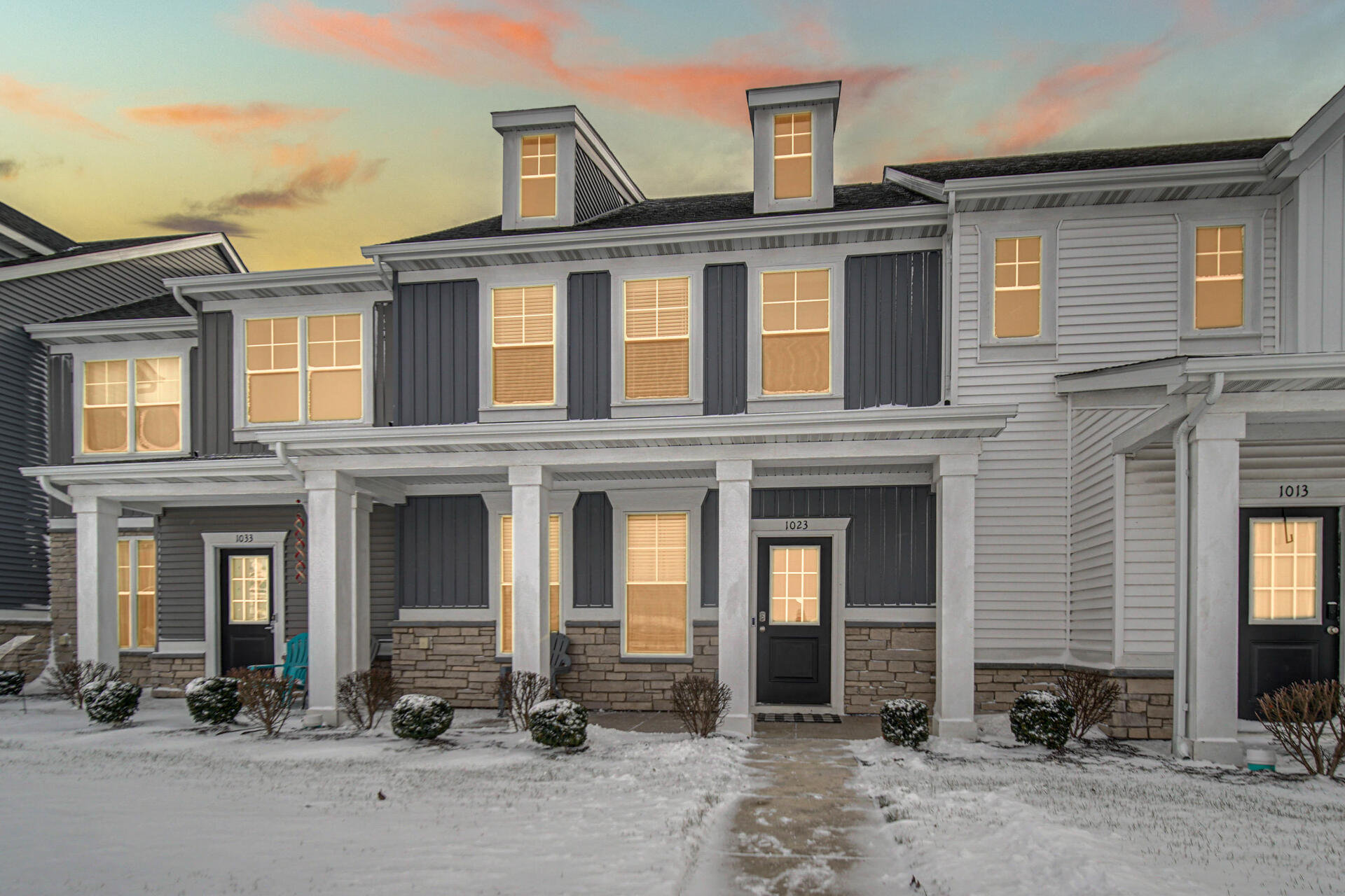 1023 East 117th Lane Crown Point, IN 46307 - Photo 2 of 22 front view of a brick house with a small yard