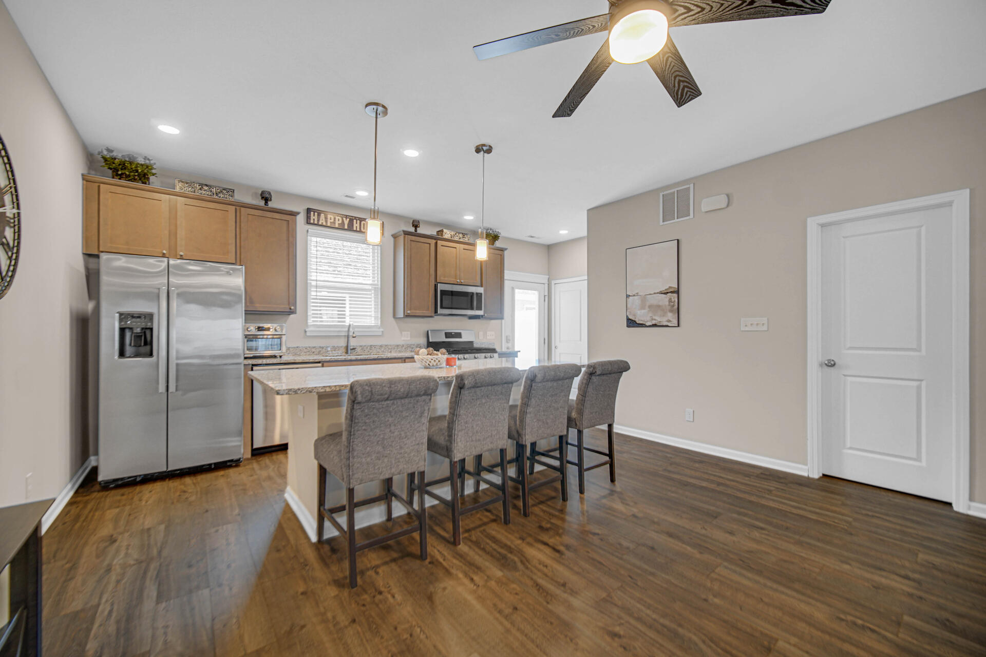 1023 East 117th Lane Crown Point, IN 46307 - Photo 8 of 22 a kitchen with stainless steel appliances a dining table chairs stove and refrigerator