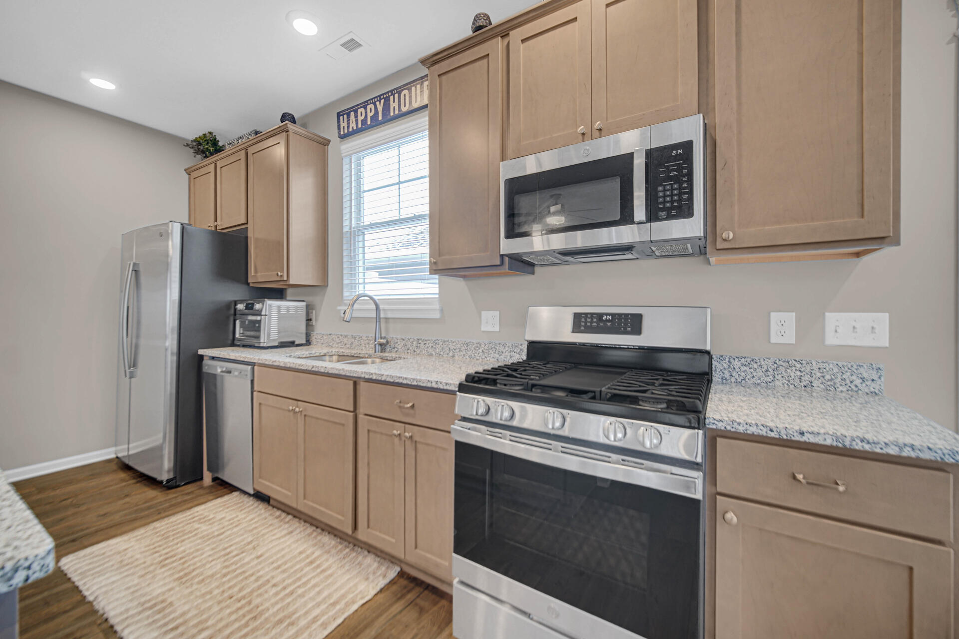 1023 East 117th Lane Crown Point, IN 46307 - Photo 10 of 22 a kitchen with stainless steel appliances granite countertop a stove microwave and sink