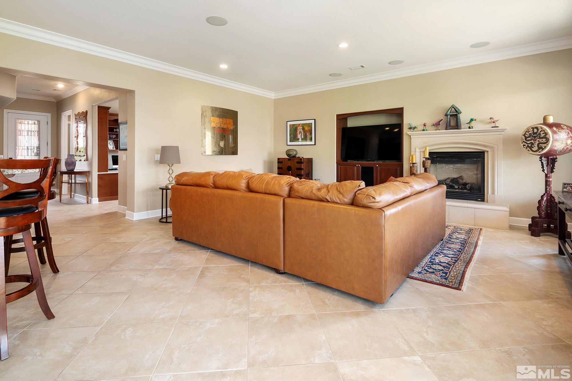 1605 Ashland Bluff Way Reno, NV 89523 - Photo 13 of 37 a living room with furniture a flat screen tv and a fireplace