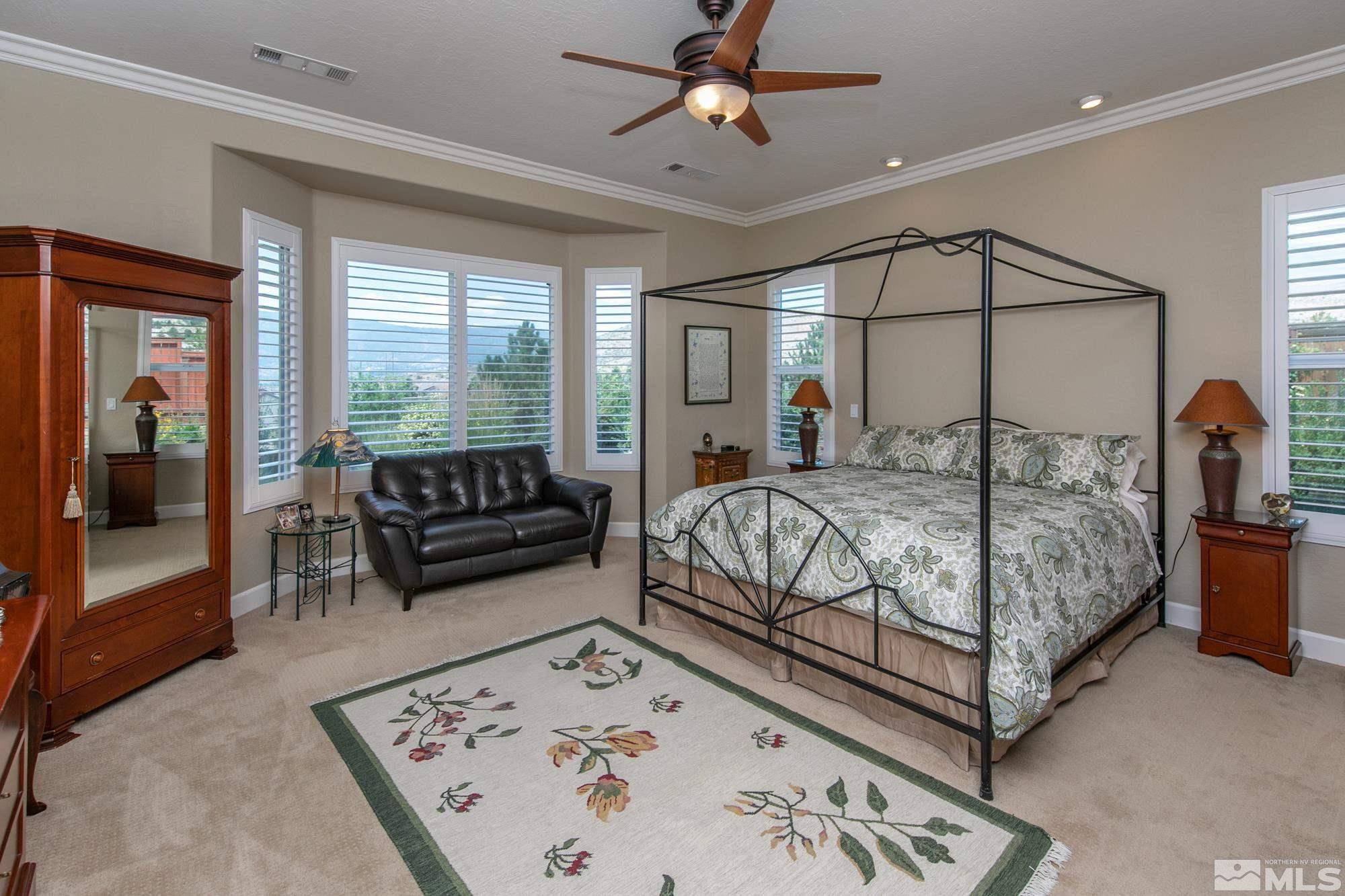 1605 Ashland Bluff Way Reno, NV 89523 - Photo 21 of 37 a bedroom with a large bed and a chandelier