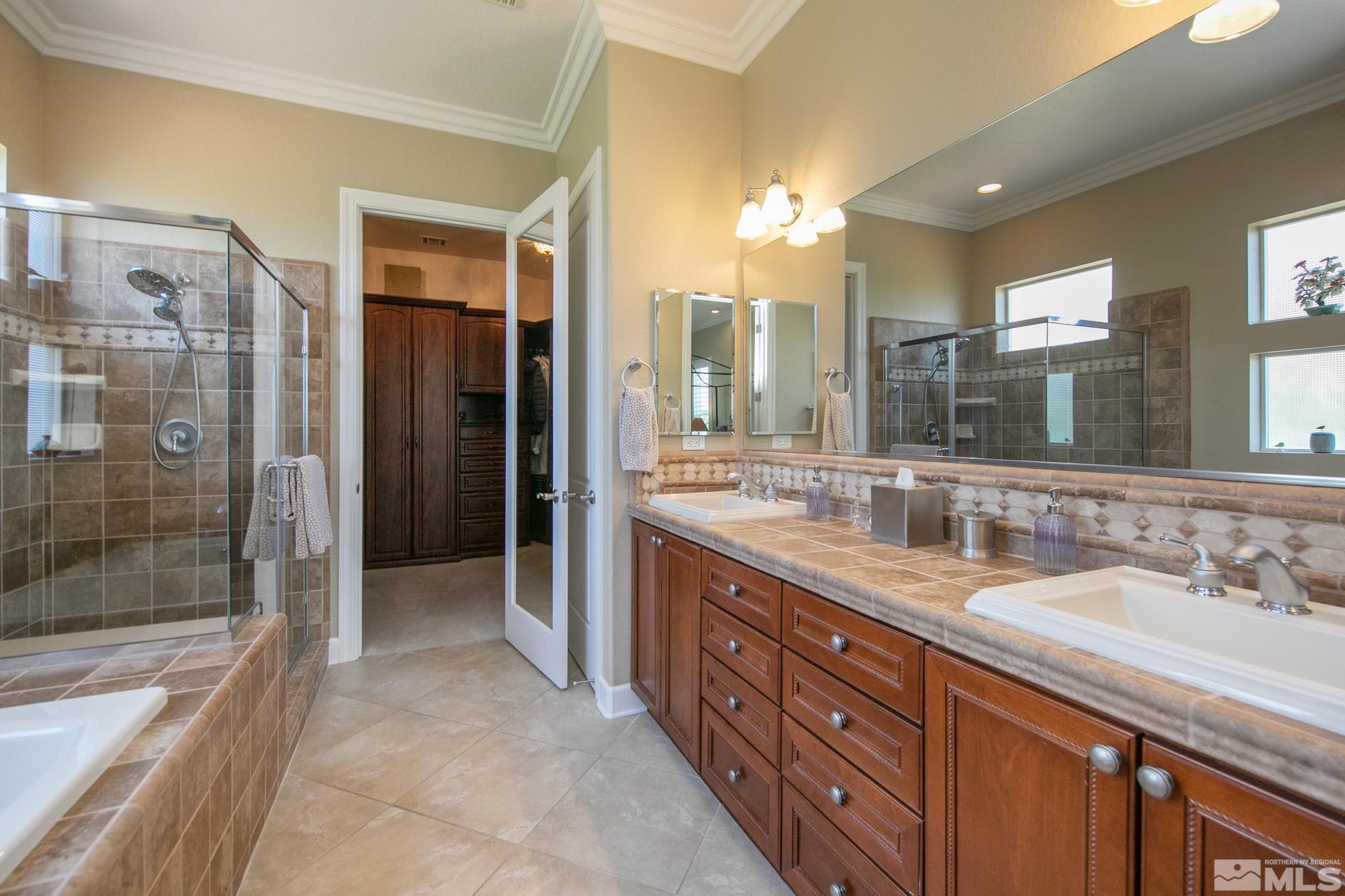 1605 Ashland Bluff Way Reno, NV 89523 - Photo 23 of 37 a spacious bathroom with a granite countertop sink mirror and shower