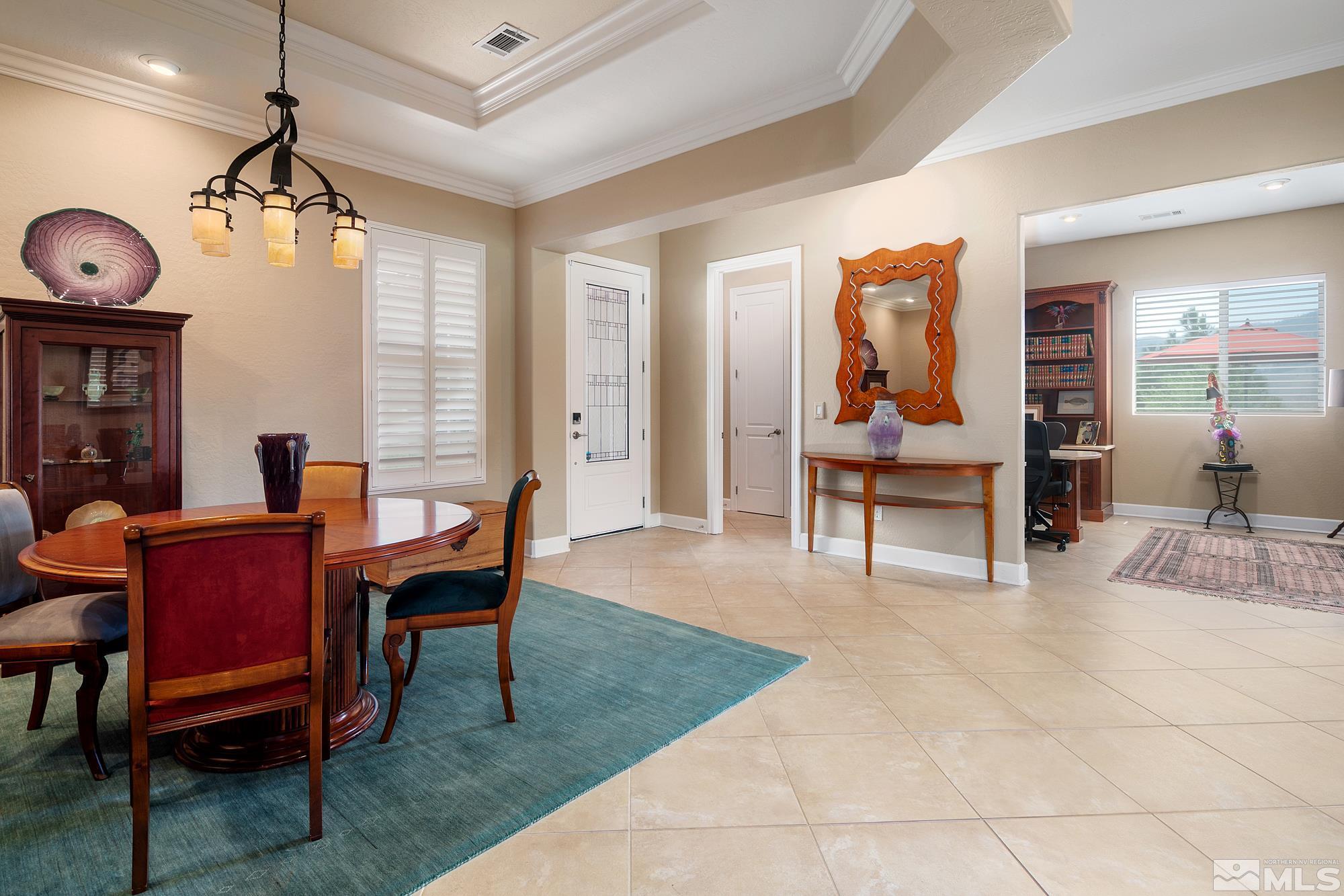 1605 Ashland Bluff Way Reno, NV 89523 - Photo 6 of 37 a living room with furniture a chandelier and a dining table