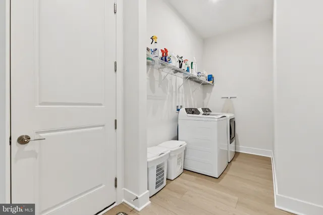 a utility room with cabinets washer and dryer