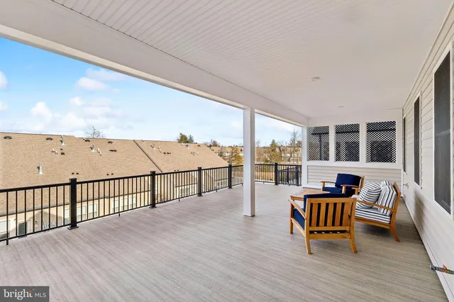a balcony with furniture and wooden floor