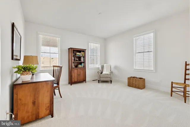 a living room with furniture and a lamp