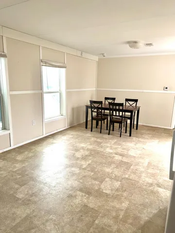 a view of dining area with furniture and chandelier