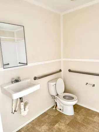 a white toilet sitting next to a bathroom sink