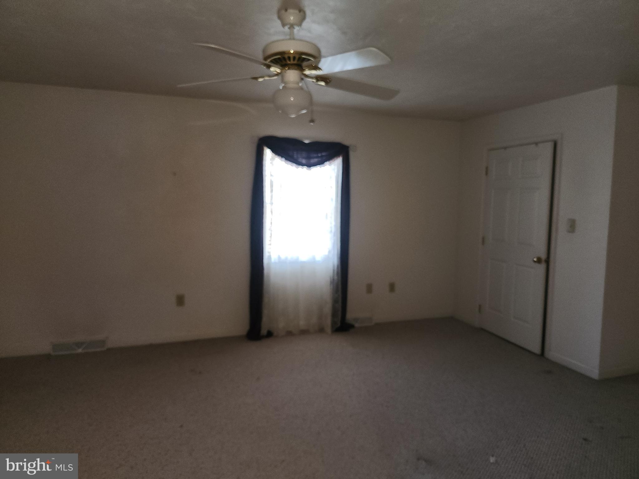 290 Locust Grove Road Bainbridge, PA 17502 - Photo 12 of 108 an empty room with a chandelier fan and windows