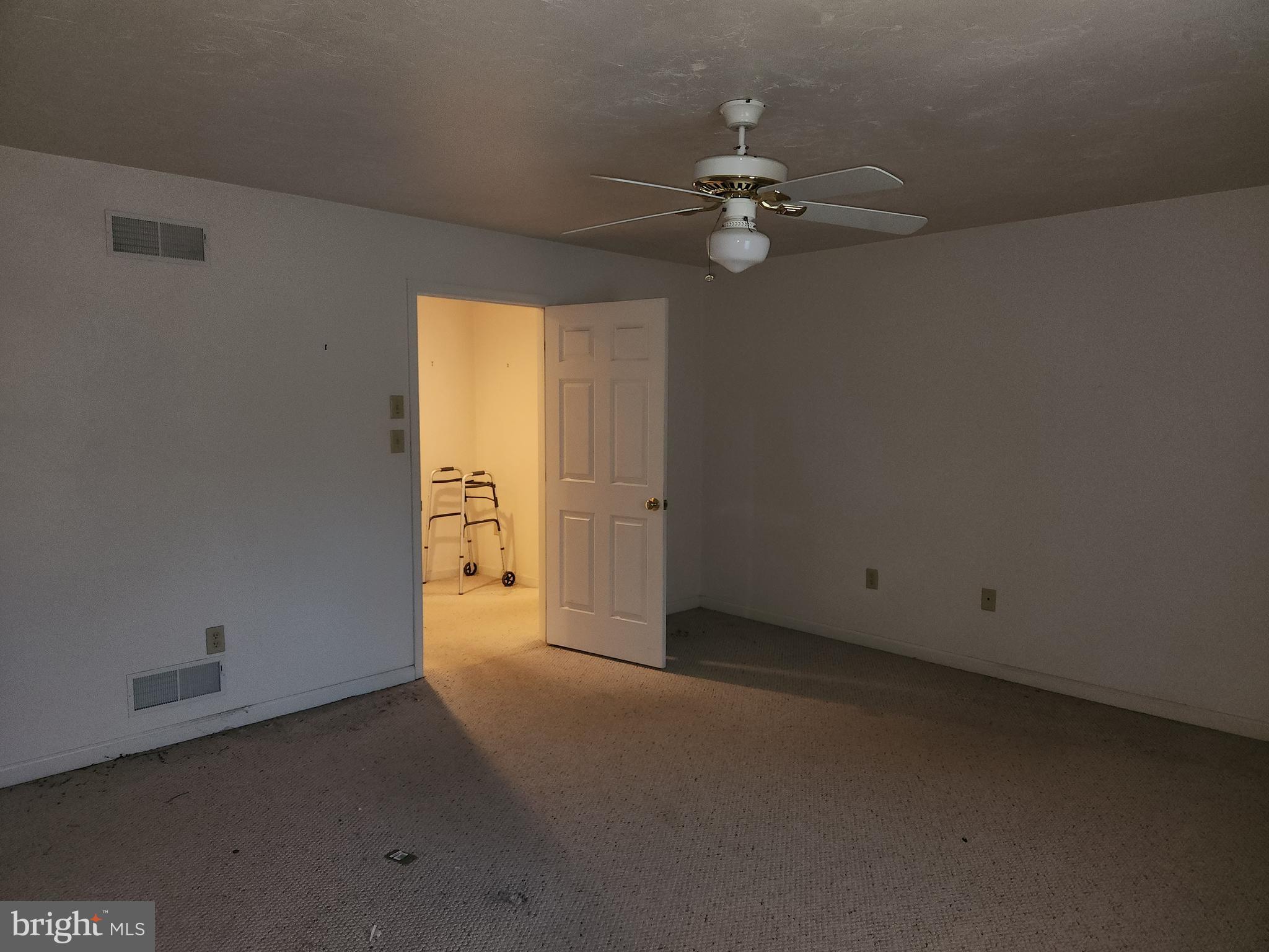 290 Locust Grove Road Bainbridge, PA 17502 - Photo 13 of 108 an empty room with a chandelier fan and windows