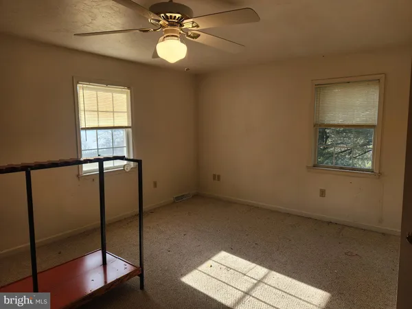 a living room with furniture a chandelier and a fireplace