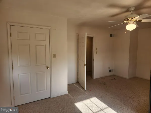 a living room with furniture window and a ceiling fan