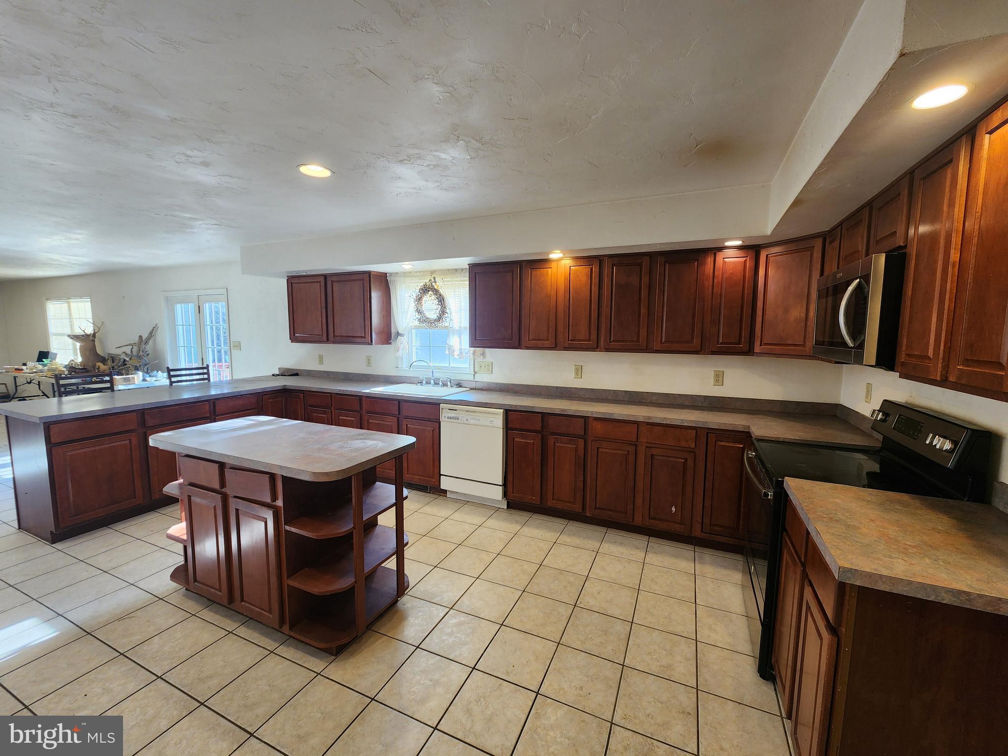 290 Locust Grove Road Bainbridge, PA 17502 - Photo 34 of 108 a kitchen with a stove a sink and a microwave