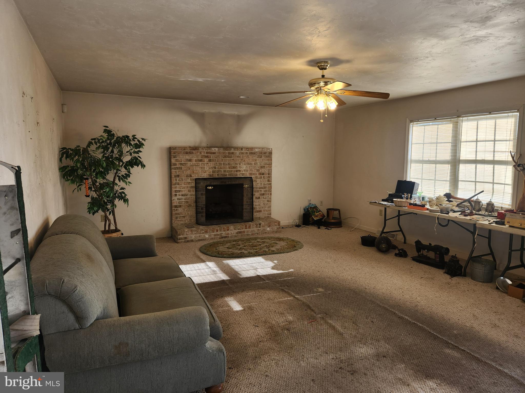 290 Locust Grove Road Bainbridge, PA 17502 - Photo 36 of 108 a living room with furniture a chandelier and a fireplace