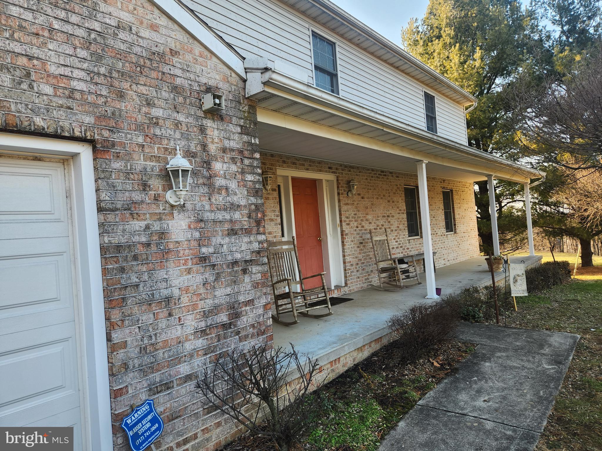 290 Locust Grove Road Bainbridge, PA 17502 - Photo 58 of 108 a view of a white house with large windows and a table and chairs