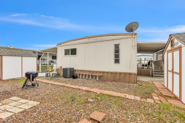 a view of a house with backyard and sitting area