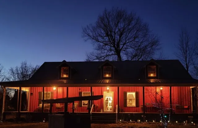 a living room with a fireplace a flat screen tv and a window