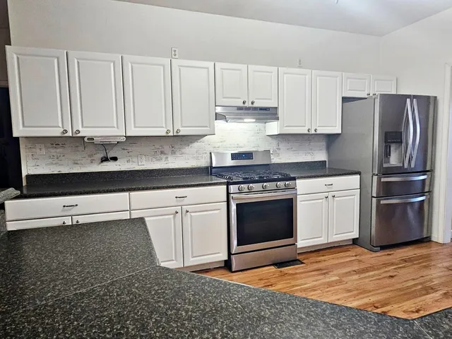 a kitchen with sink cabinets and window