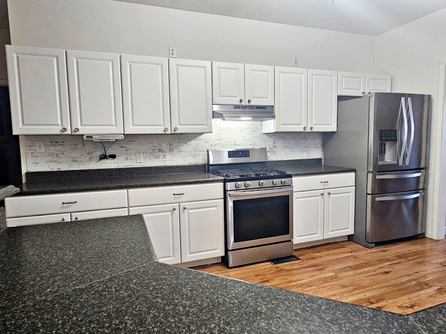 1600 Scott Street Metropolis, IL 62960 - Photo 6 of 23 a kitchen with granite countertop white cabinets and stainless steel appliances