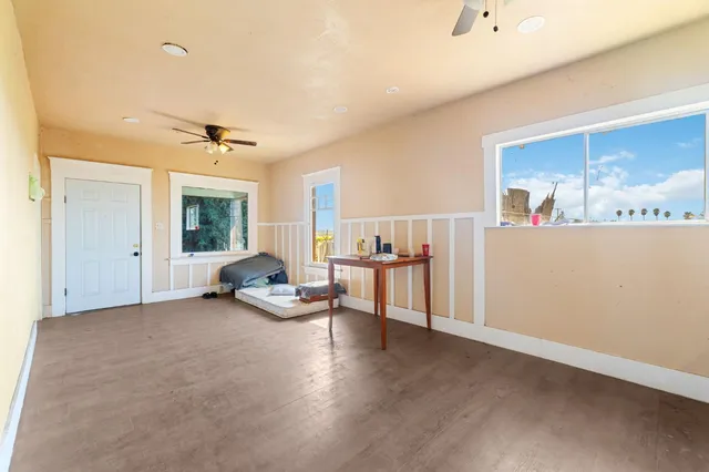 a dining hall with stainless steel appliances granite countertop a sink and a white cabinets