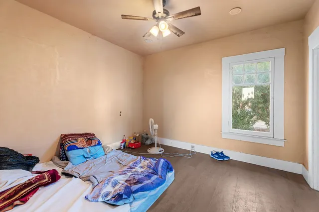 a kitchen with stainless steel appliances wooden floor sink and wooden cabinets