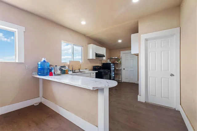 a view of a workspace with furniture and a window